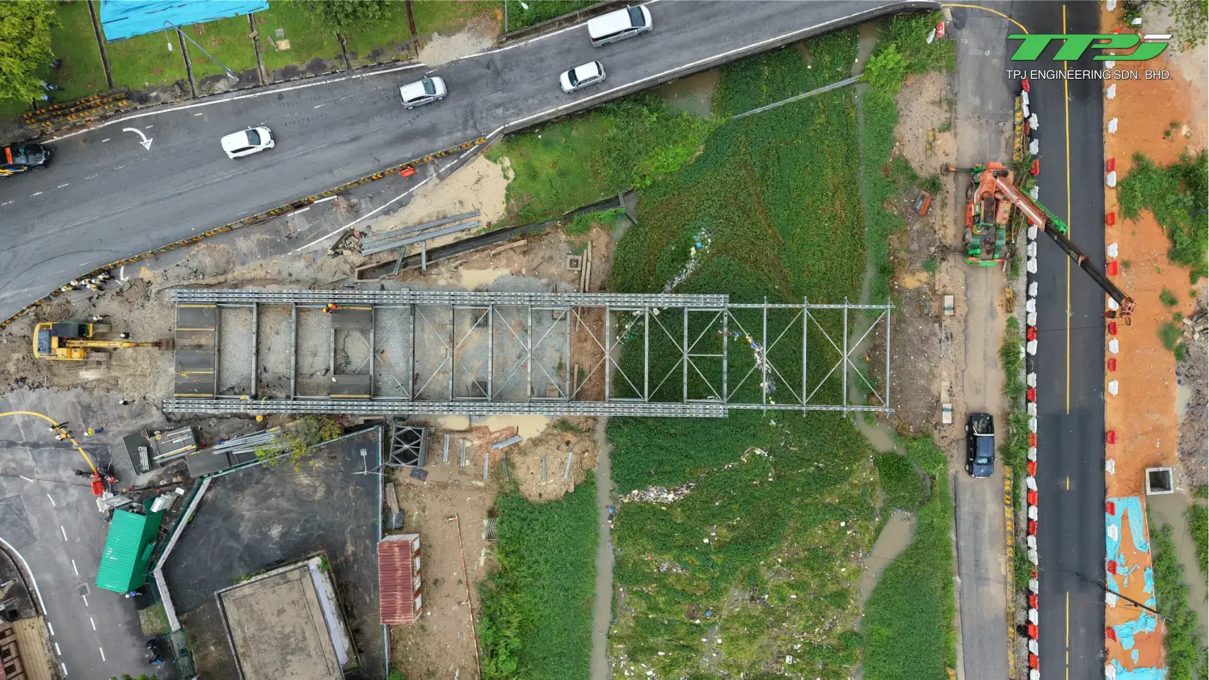 Top-down aerial view of the bridge alignment, access roads and riverside works at Carrefour, Seberang Jaya.