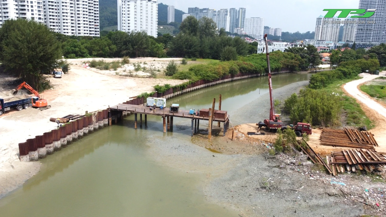 Crane beside a temporary working platform and sheet piles during initial Water Body A works at Gurney Bay