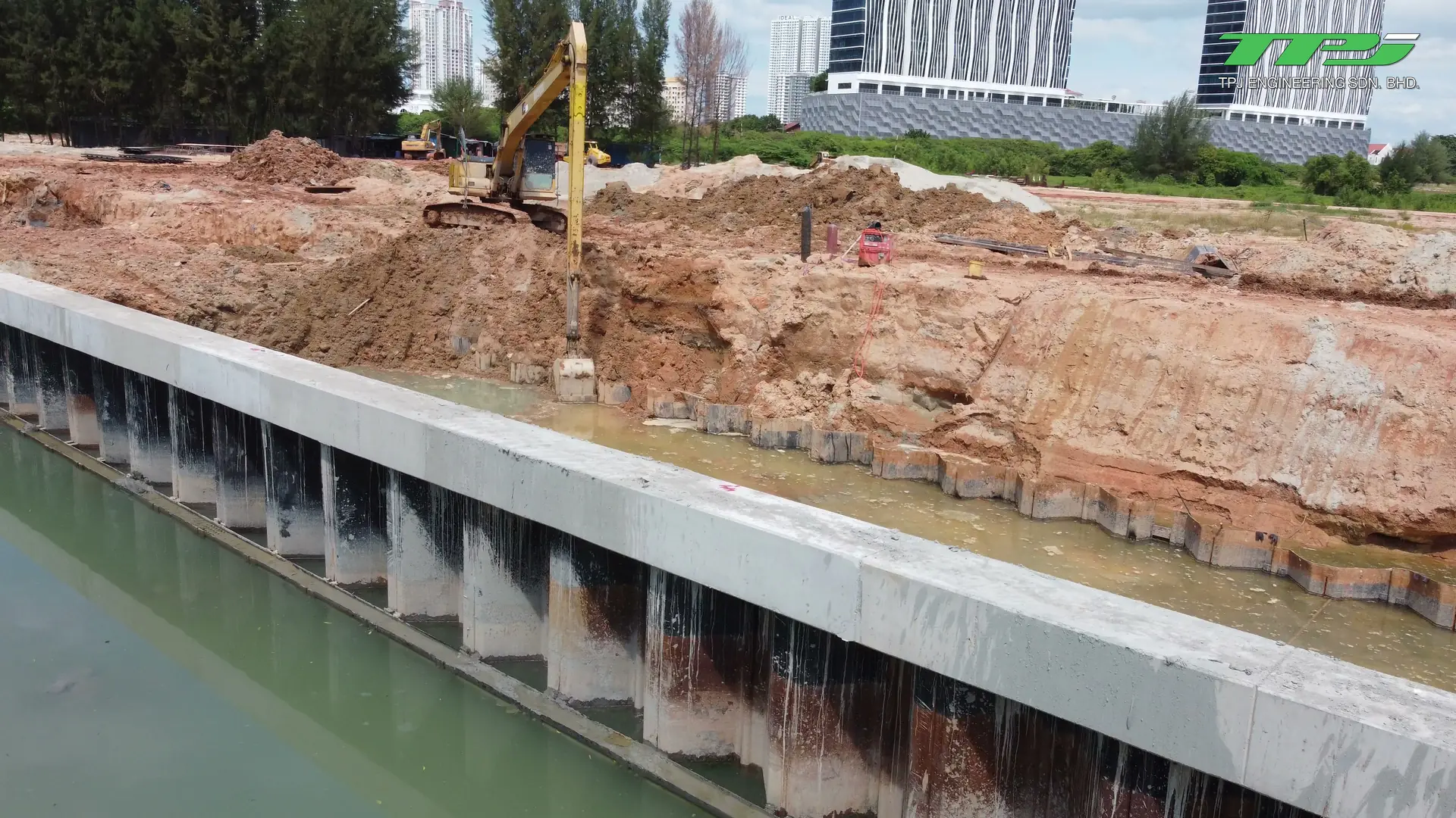 Excavator working beside a water-filled trench within the Water Body A reclamation area