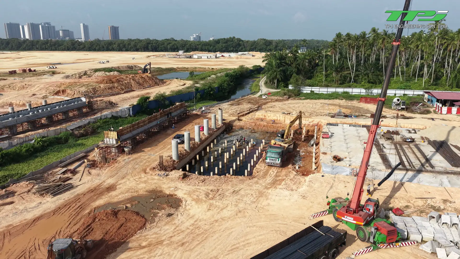 Aerial view of a crane, rows of concrete piles and foundation works at the Batu Kawan bridge site, Penang.