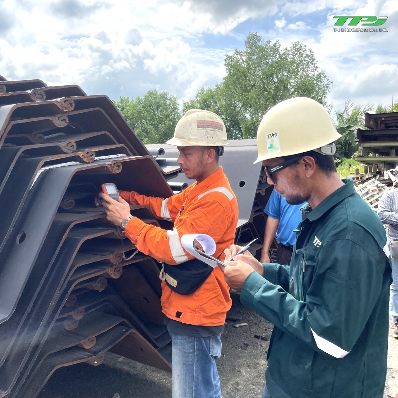 Personnel checking steel sheet-pile sections and recording inspection results for Water Body A