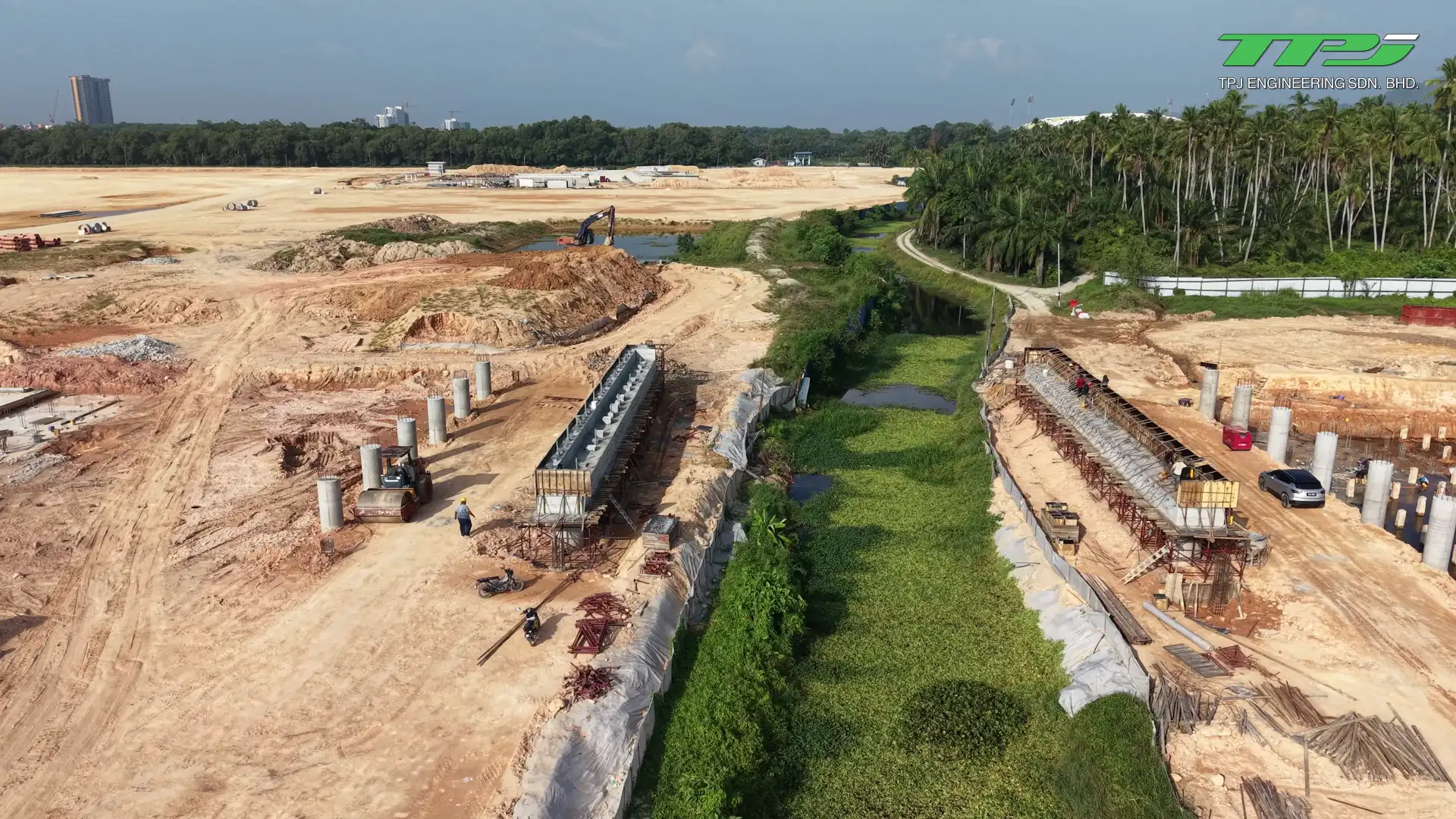 View along Sungai Binjai between rows of bridge supports and earth embankments at Batu Kawan, Penang.