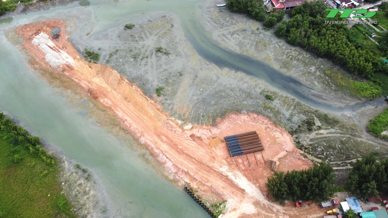 Aerial view of the initial access embankment and stacked sheet piles at Water Body A, Gurney Bay