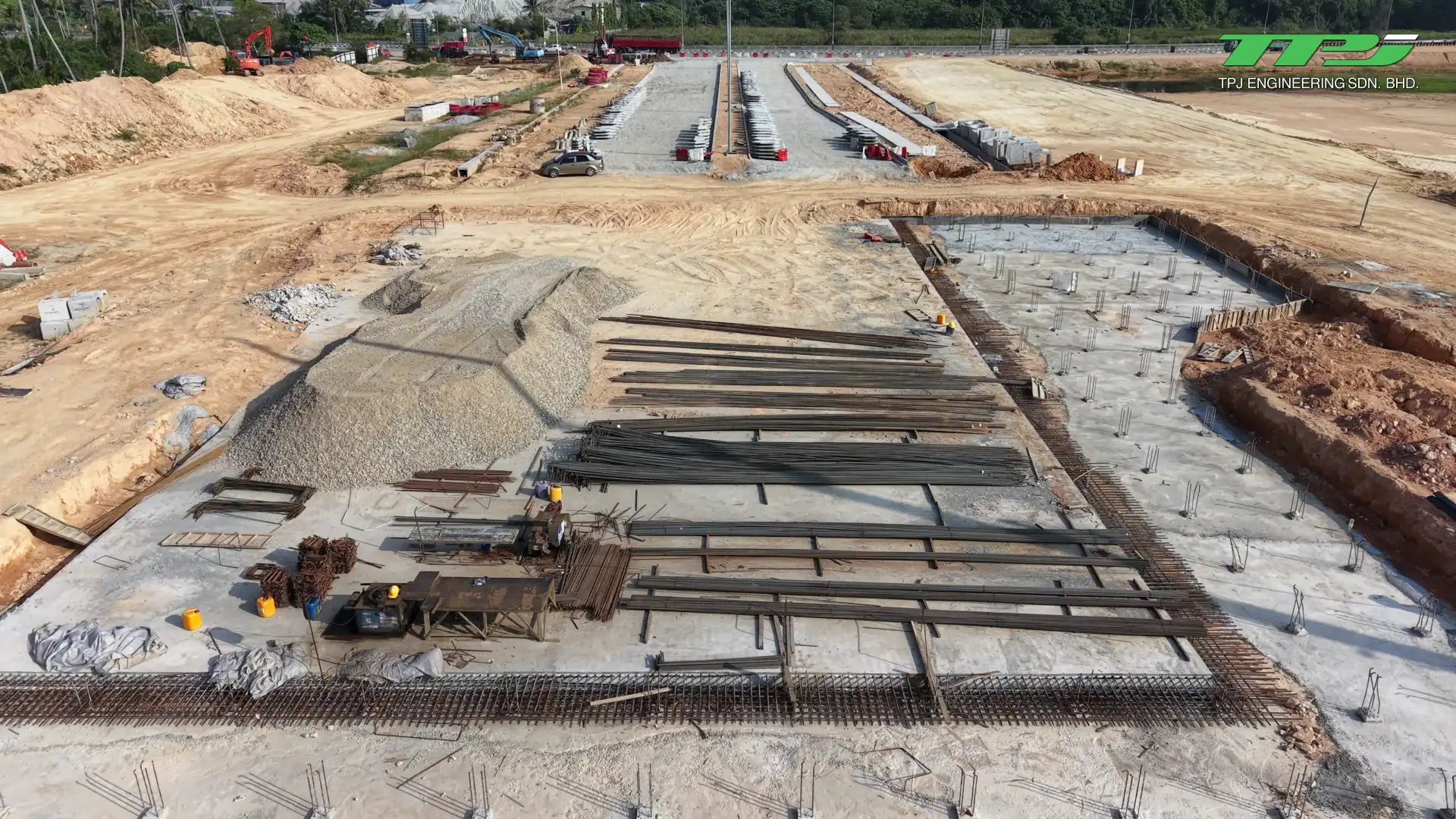 Aerial view of a prepared foundation area, reinforcement and concrete elements at the Batu Kawan bridge site.