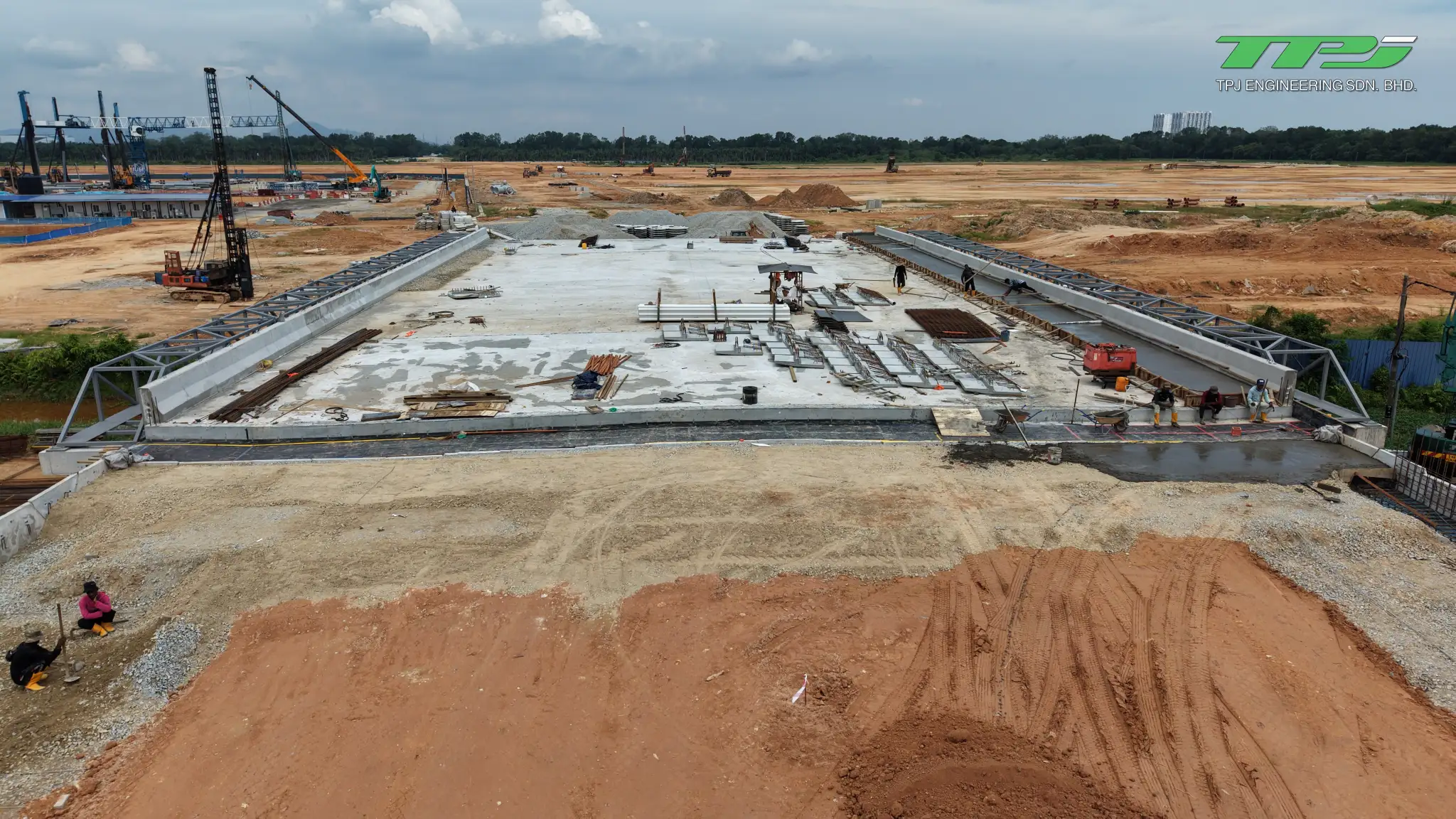 Batu Kawan bridge deck viewed from the earth approach, with construction materials on the deck.
