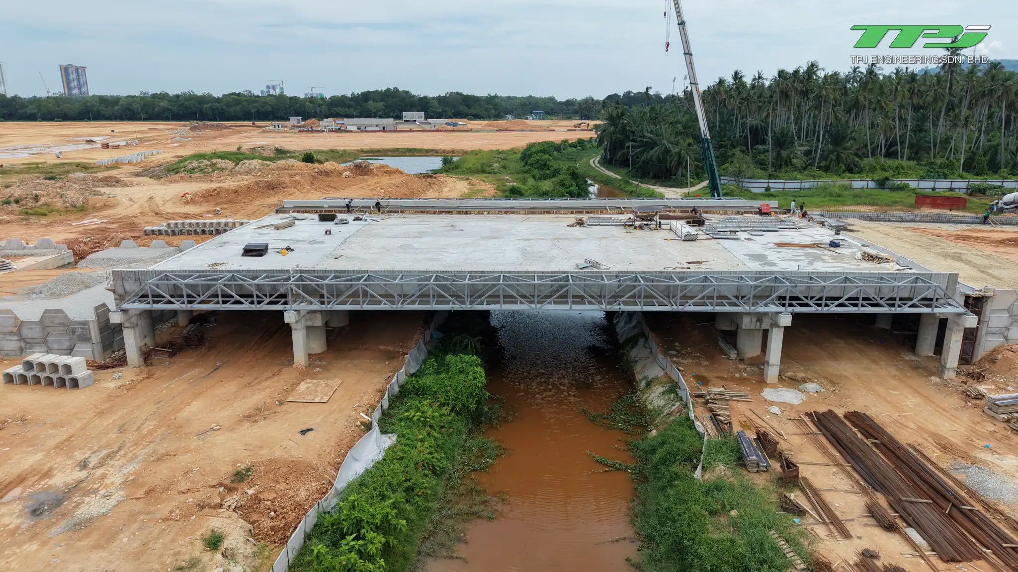 Concrete bridge deck across Sungai Binjai with temporary steel gantries at the Batu Kawan site, Penang.
