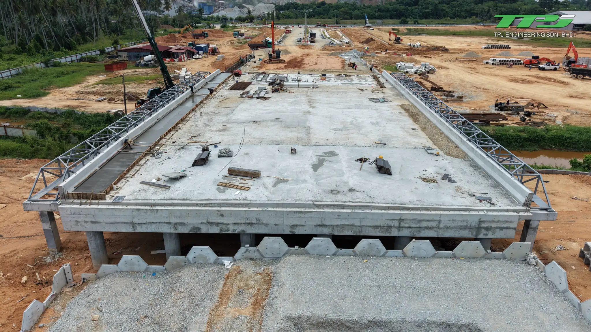Batu Kawan bridge viewed from the approach, showing the deck, beams below and concrete retaining wall panels.